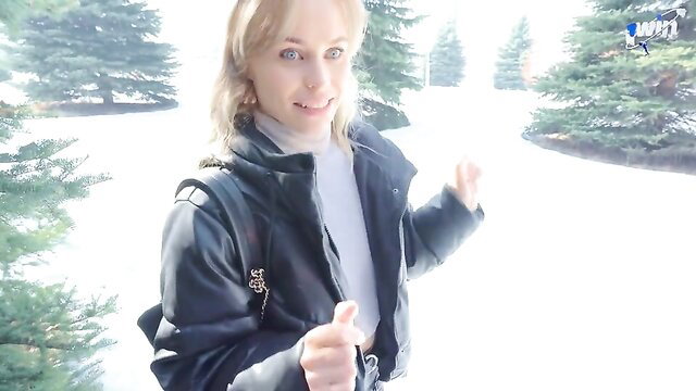 Gorgeous blonde whore in sexy black jacket thumbs up outdoors snow