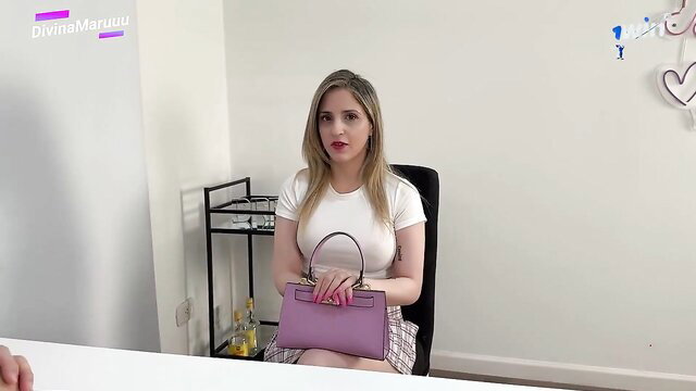 Divina Maruuu blonde in tight white top and plaid skirt holding purse