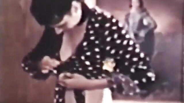 Vintage brunette bombshell unbuttons polka dot robe exposing cleavage
