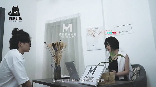 Two Asian women in interview, one in white tee, other in sexy green top