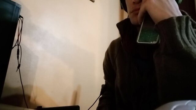 Cute Latino guy fondles himself on cam, headphones and green phone