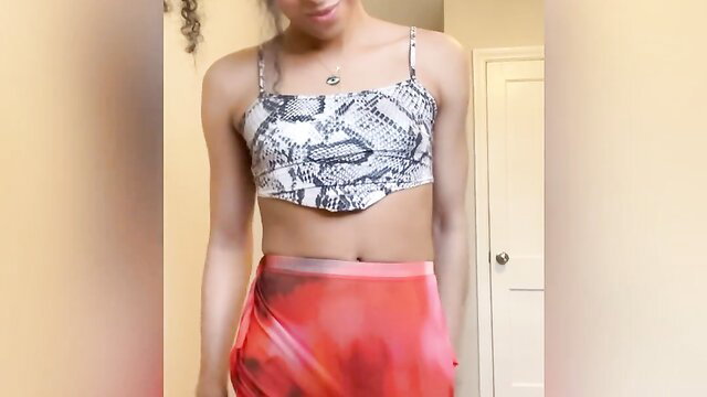 Luma Lavont teasing in snakeskin crop top and sheer red skirt