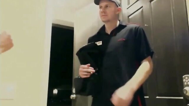 White repairman in black polo holds black case in doorway, amateur thumbnail