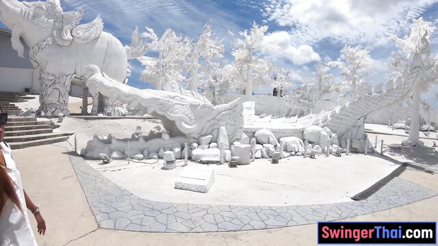 Stunning white Thai temple with giant ice sculptures and sexy woman in dress