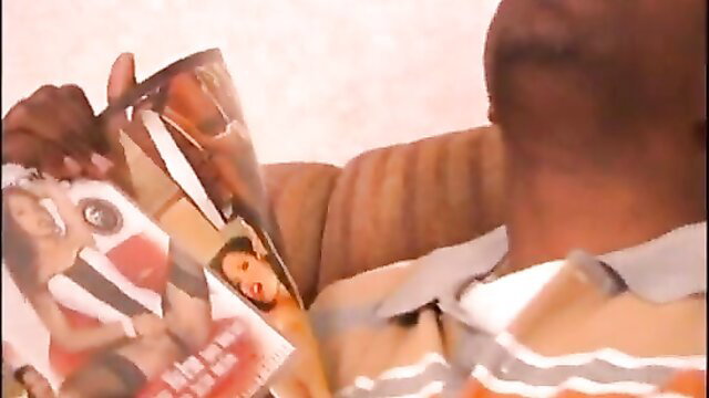 Mika Brown holding explicit porn magazine cover with nudes
