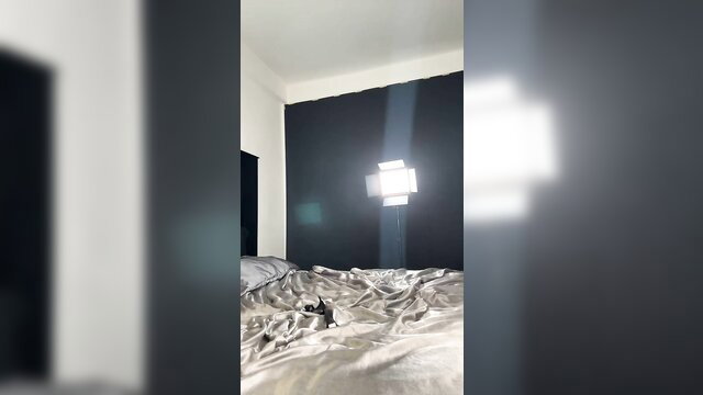 Franco Robert in bed with dramatic backlit window glow