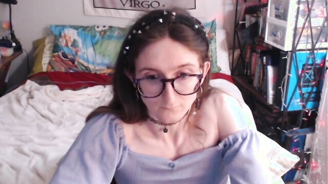 Glasses-wearing brunette Paige in off-shoulder top, teasing cleavage closeup