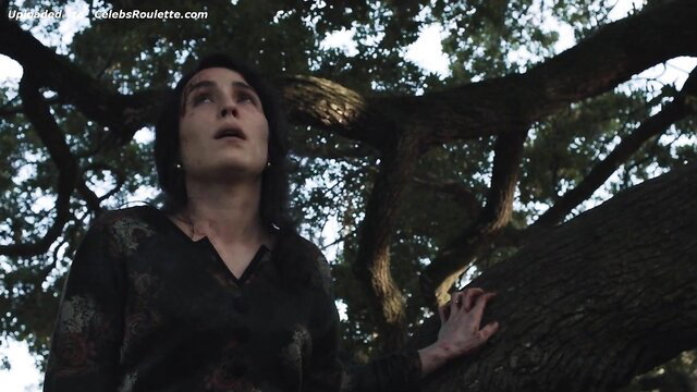 Noomi Rapace looking up intensely in forest, The Secrets We Keep 2020