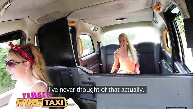 Busty tattooed blondes in orange tops flirt in Fake Taxi cab