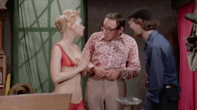 Blonde babe in red bikini pleads with two men in steamy genie threesome scene