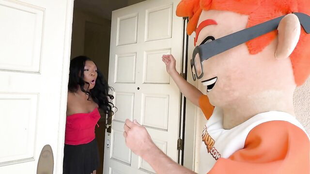 Asian babe in red tube top black skirt greets orange mascot fursuit at door