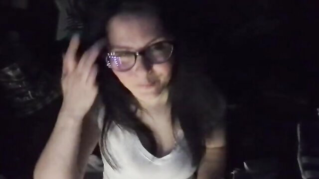 Morgana Laveau in glasses and tank top, hand on hair, seductive glance