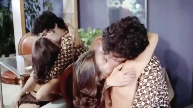 Jamie Gillis passionately kisses Leslie Bovee in steamy 70s scene