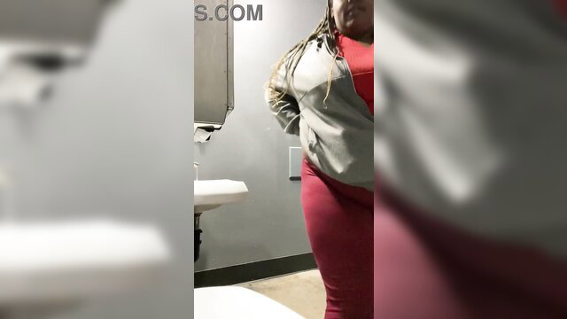 Hot BBW black woman in red leggings poses in bar restroom