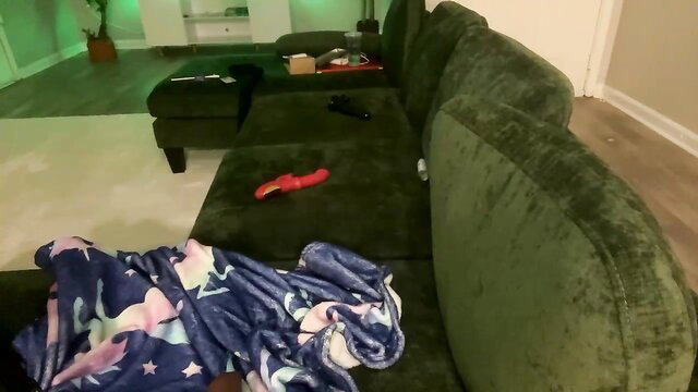 alongcamelexy on green couch with pink unicorn blanket and red dildo