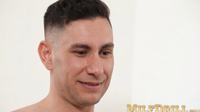 Handsome man smiling in MILFDril video thumbnail with Kira Queen