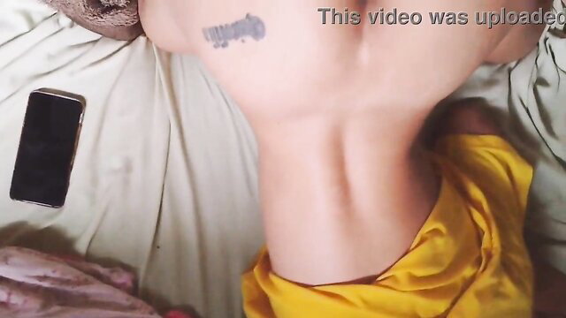 Curvy woman's tattooed arched back in yellow saree, intense anal play tease