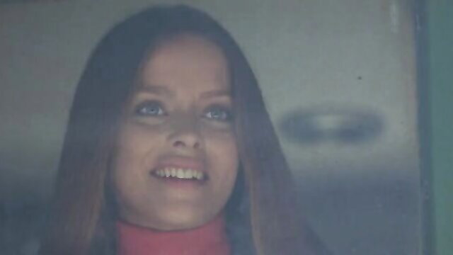 Ingrid Thulin smiling closeup in red turtleneck from 1971 nude celebs film
