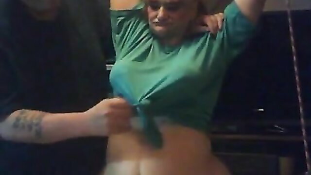 Ugly old slave girl tied up, arms bound, humiliated in tied green shirt