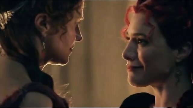Two busty redhead women in ancient Roman attire gazing intimately in Spartacus parody