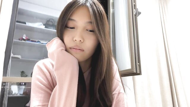 michalkandoll shy young Asian camgirl in pink hoodie closeup