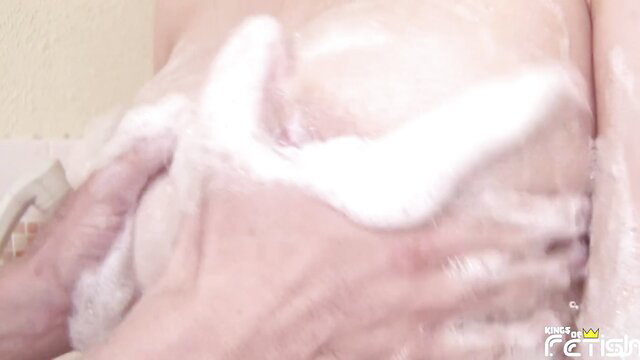 Japanese woman soapy tits lathered by hand in JAV shower scene