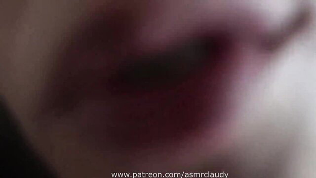 Blurry closeup of ASMR Claudy Schoolteacher's glossy red lips parted seductively