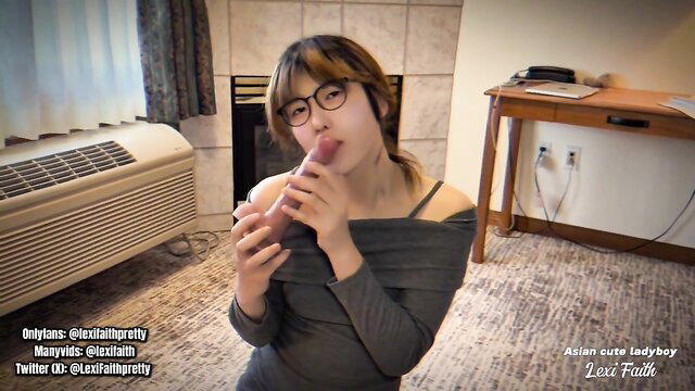 Asian femboy Lexi Faith sucking dildo in off-shoulder top