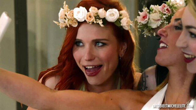 Redhead bride Candie Luciani in flower crown smiling with friend selfie