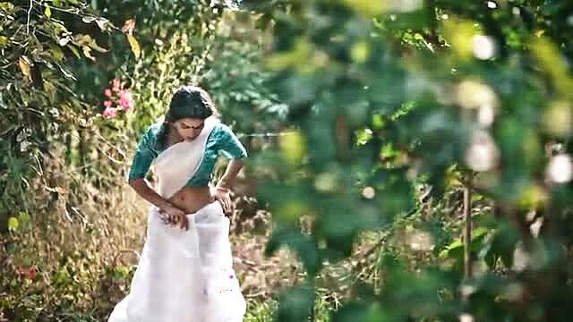 Resmi R Nair in sheer white saree adjusting blouse, hot Indian midriff tease