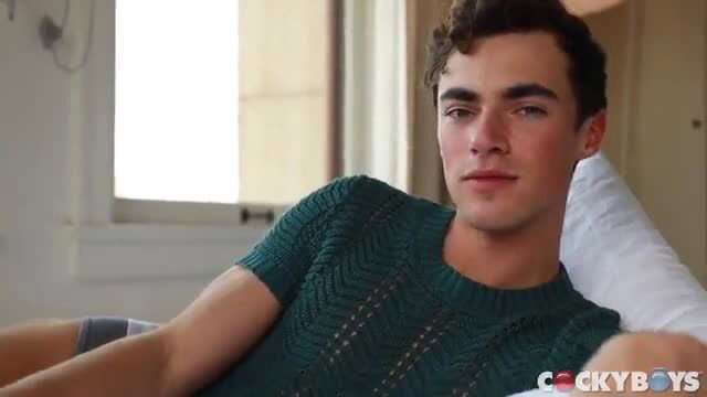 Nick Floyd in green sweater reclining, Trevor Brooks CockyBoys modeling shoot