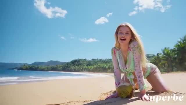 Blonde bombshell Abbegaile Moore in sexy swimsuit on tropical beach