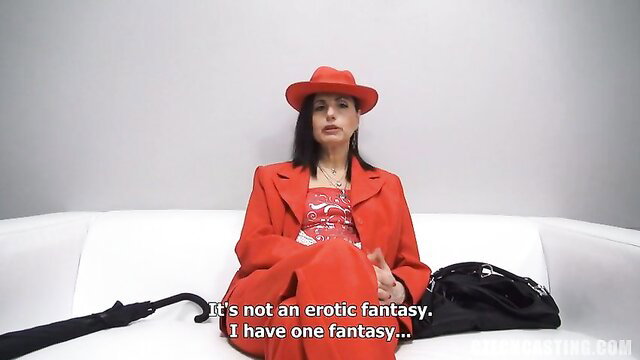 Amateur Dana in red suit and hat sits seductively on couch