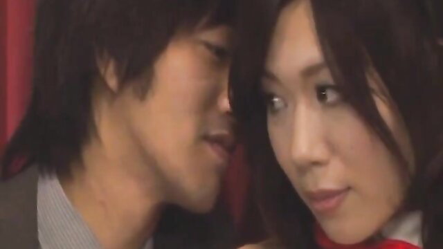 Asian bunny girl waitress in red bowtie whispers intimately to suited man
