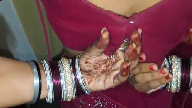 Indian Bhabhi in red plunging dress showing cleavage and henna hands