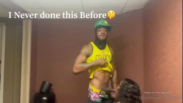 Miss B ebony shemale in yellow Celtics tank, pink thong, green balaclava