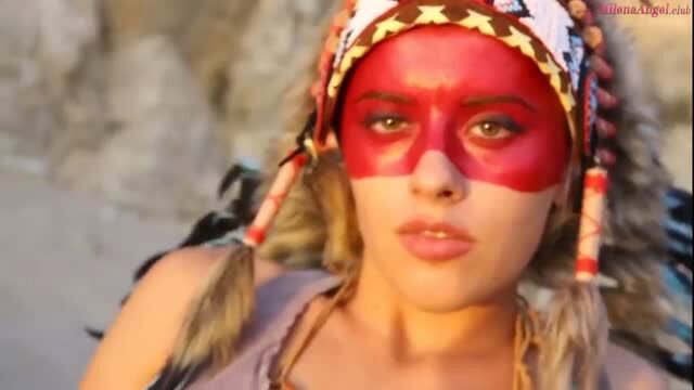 Blonde bombshell in sexy Native American costume with red face paint