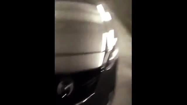 Blurry car wash scene with black vehicle closeup