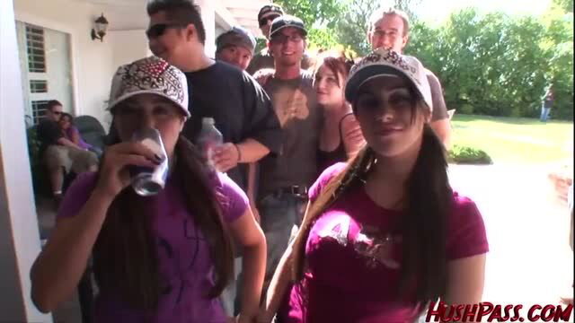 Brunette teen drunk at frat party holding beer bong