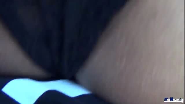 Close-up of Karyn Bayres in sheer black lingerie and striped bottoms