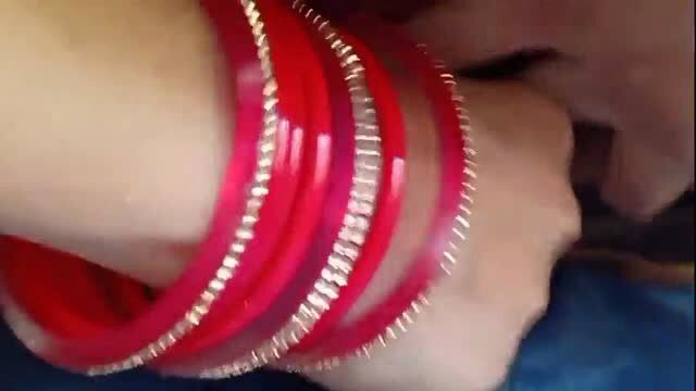 Red bangles on wrist during outdoor sex scene