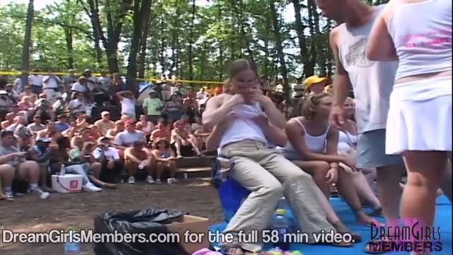 Blonde wife in wet white tank top during outdoor wet t-shirt contest