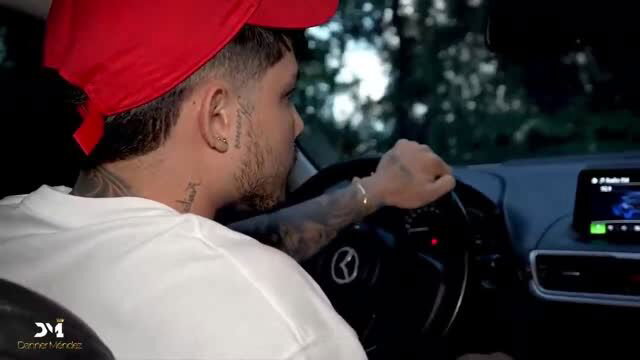 Tattooed man in red cap driving Mercedes, visible face tattoos and ink