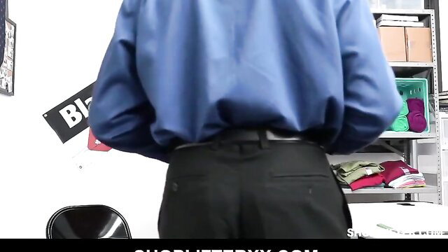 Ellie Eilish in tight blue shirt black pants bent over in shoplifter scene