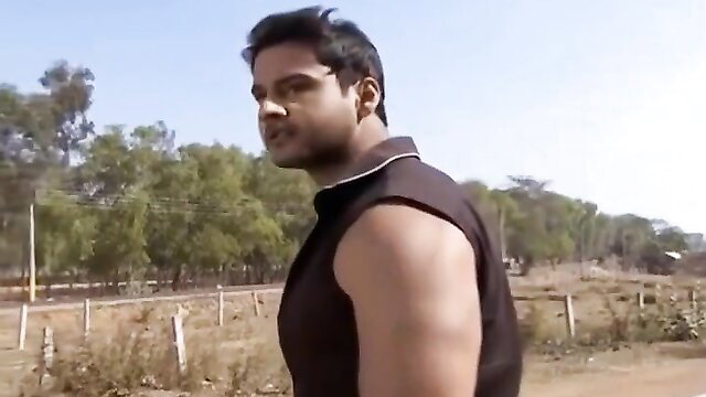 Muscular Indian man in tank top, side profile outdoor BDSM scene
