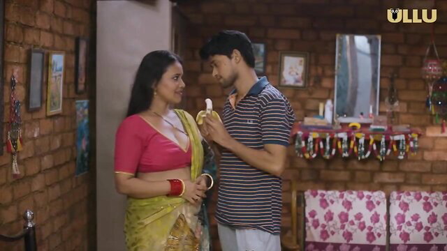 Desi Indian bhabhi in yellow saree feeds banana to young guy closeup