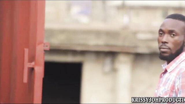 Handsome Black man in checkered shirt peeking from red door in Ezega Sex