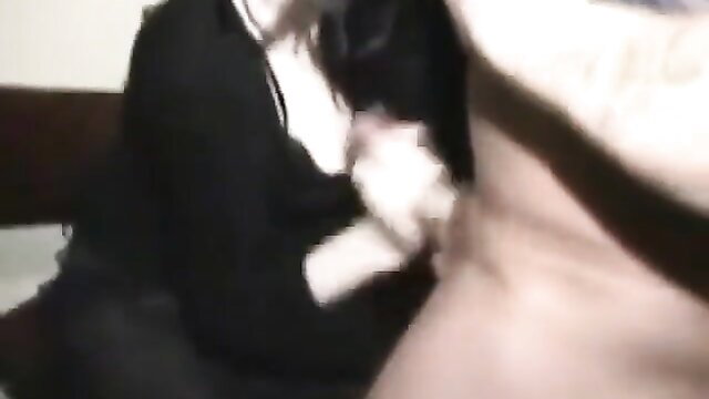 Blonde giving backstage blowjob to man in dim light