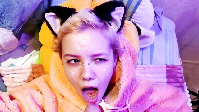 Cute platinum blonde catgirl in pink robe with open mouth on bed