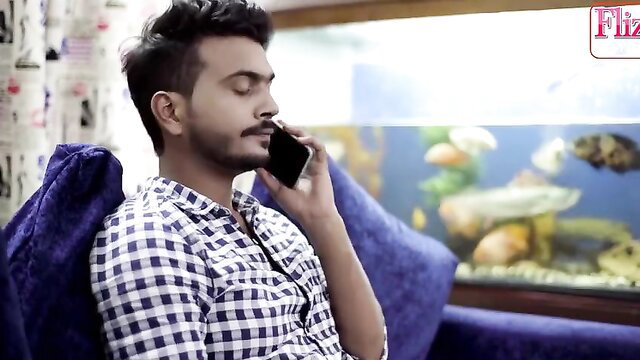 Young Indian guy on phone in checkered shirt, swinger couple swap thumbnail